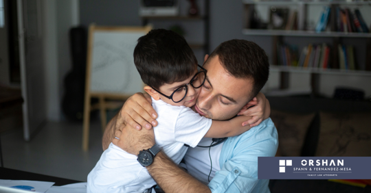 A father and son hugging.