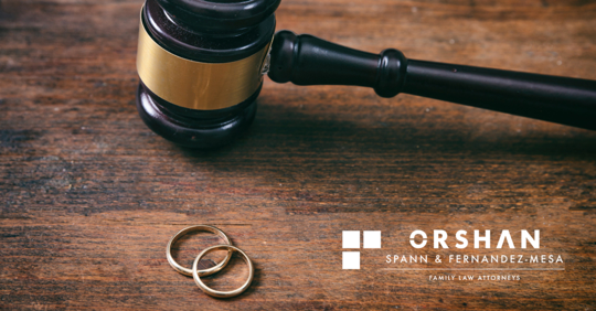 Gavel and wedding rings on a table.