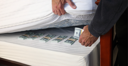 Man hiding money under mattress